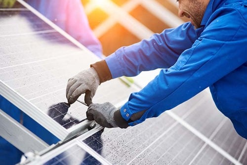 man working on solar panel