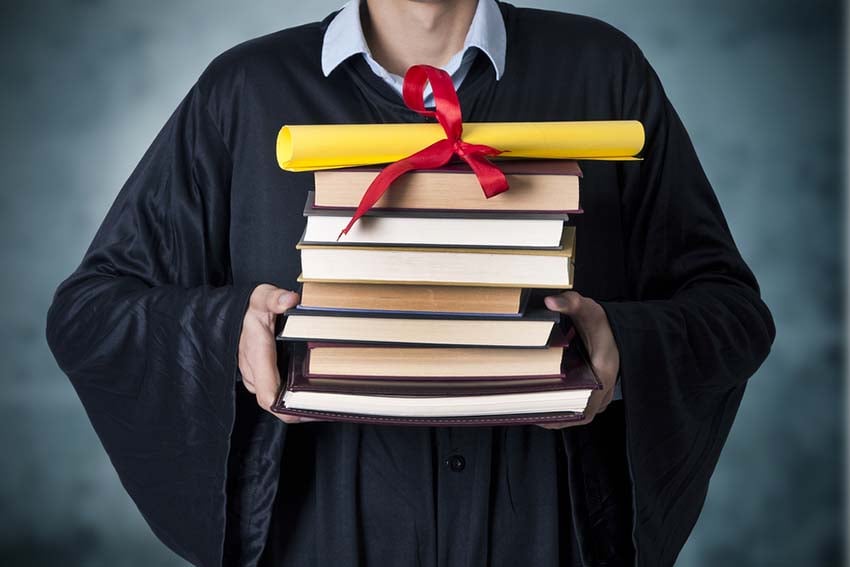 Student Holding Stack Of Books